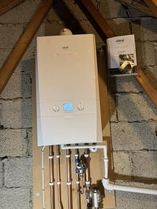 Luke fitting a new boiler in a tight loft space